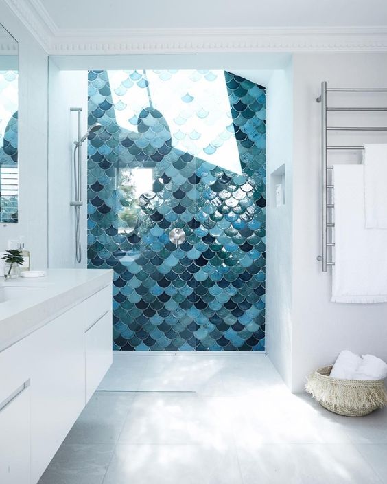 the shower done with fish scale tiles and a skylight makes showers a spa experience while keeping them private