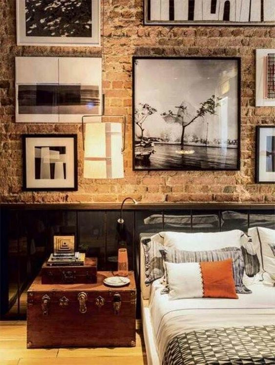 a vintage wooden trunk adds personality to this industrial masculine bedroom