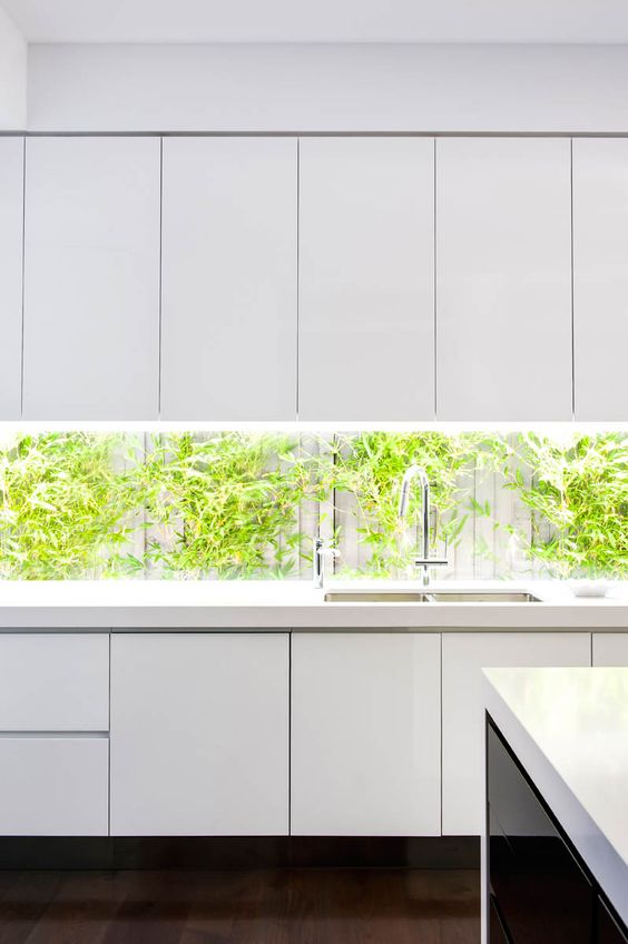 an all-white look could be boring if not a window backsplash with much greenery in the yard