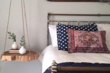 16 a natural hanging bedside table of rope and a raw edge wood piece for a rustic space