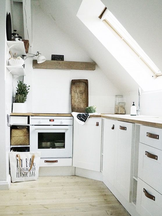 a small contemporary kitchen with rustic wooden touches and a skylight instead of a window