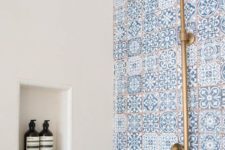 16 blue mosaic tiles and copper fixtures will make your shower very coastal-like
