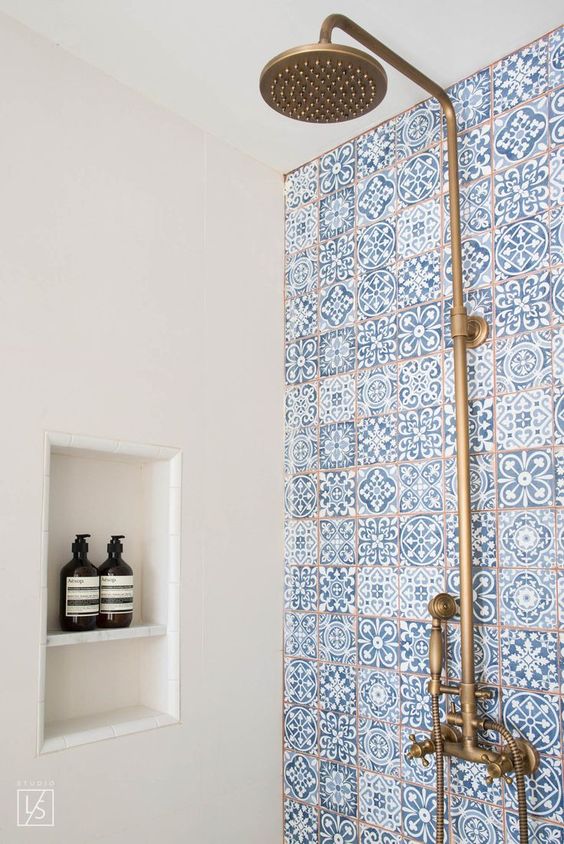 blue mosaic tiles and copper fixtures will make your shower very coastal-like