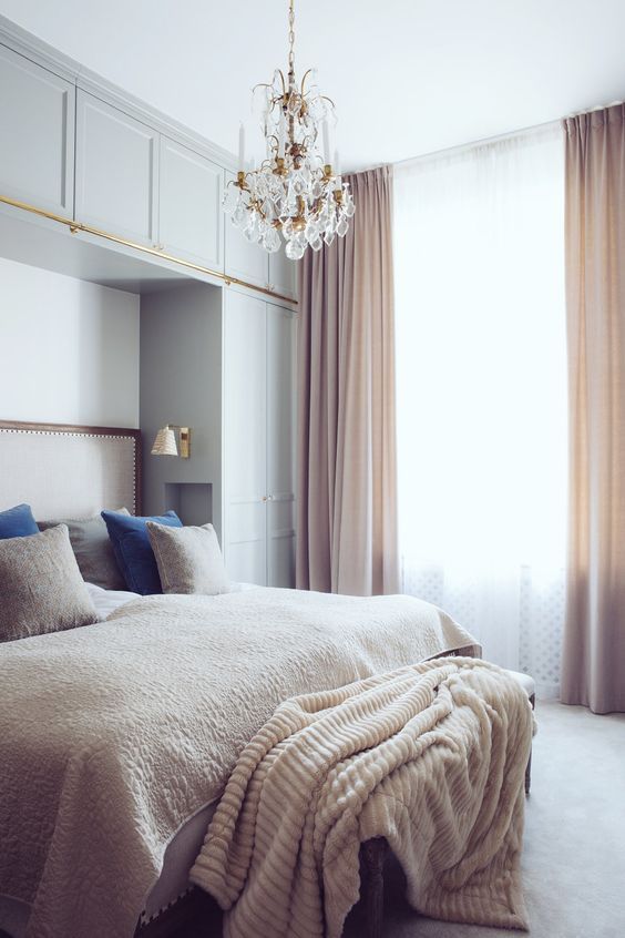 light blue cabinets and blush curtains to make the bedroom more interesting and welcoming