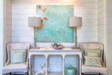 17 a beach console table, a coral, a bottle, a driftwood bowl and an oversized artwork