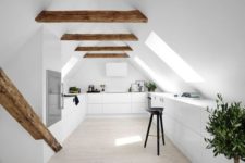 17 a minimalist white space with wooden beams and many skylights that fill the space with light