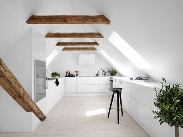 a minimalist white space with wooden beams and many skylights that fill the space with light
