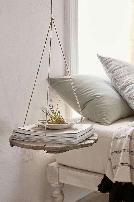 a rustic hanging nightstand of rope and a wood piece for a rustic vintage bedroom