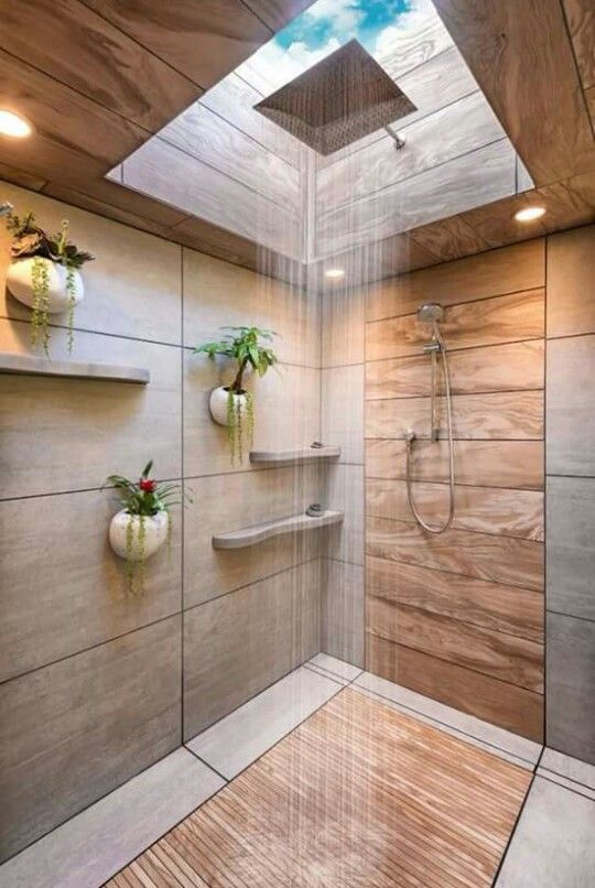 a shower done with wood and stone plus a skylight creates a very natural feel while taking a shower