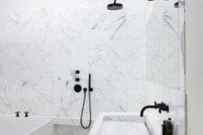 17 white marble tiles plus black fixtures for a bold modern look in the bathroom