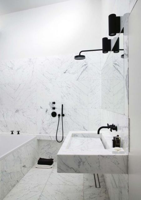 white marble tiles plus black fixtures for a bold modern look in the bathroom