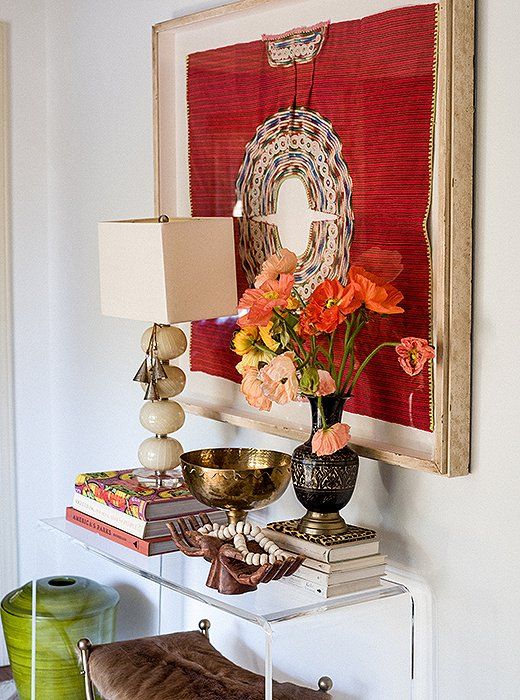 a bold artwork, bright blooms, some finds from trips for an inspiring entryway
