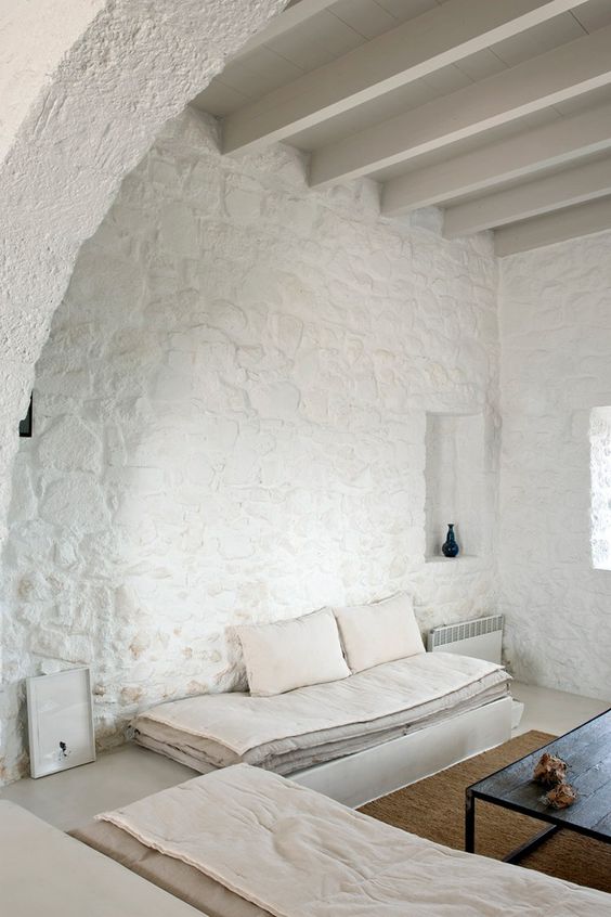 Natural stone walls painted white look very bold and catchy while being all neutral
