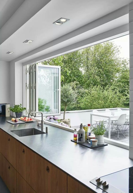 a folding window can be a nice idea to connect the kitchen to outdoors and easily serve food outdoors
