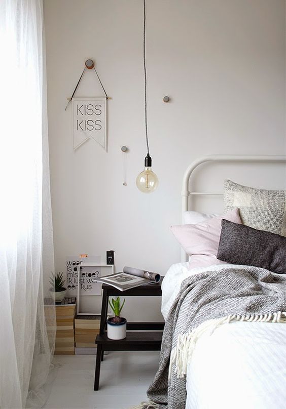 a small black ladder can be a nice nightstand idea for a Scandinavian bedroom