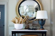 22 a nautical console with rope in a cloche, corals, a navy lamp and an artwork for a whimsy look