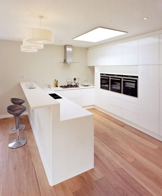 a kitchen island with a raised bar part can be used for both having breakfast and drinks