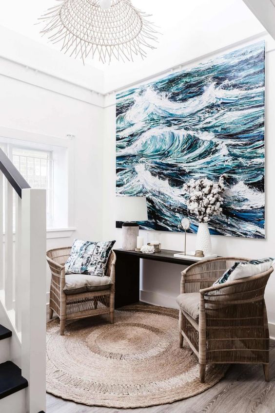 an oversized seaside artwork takes over this small space and makes it wow