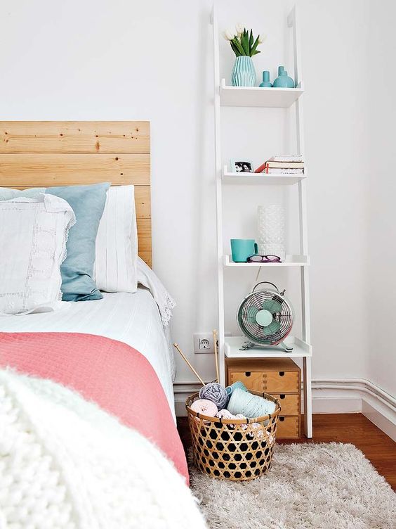 a tall ladder nightstand for much open storage and a tiny trunk under it