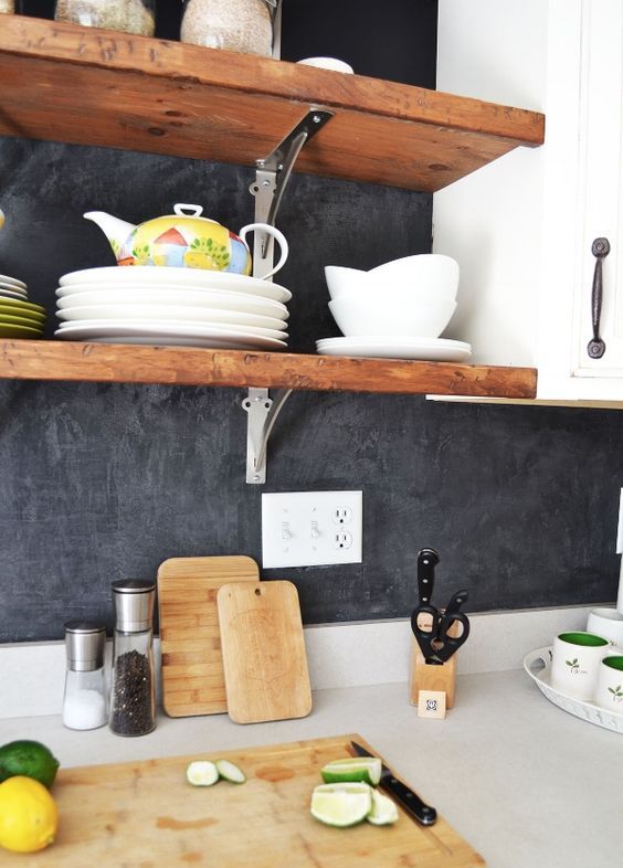 black plaster backsplash, white cabinets and wooden shelves for a bright modern look