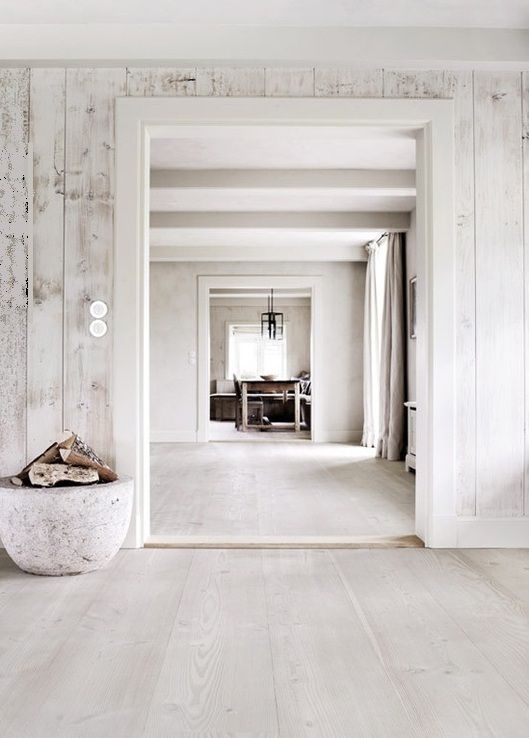 whitewashed wood walls and floors make the spaces airy and light-filled