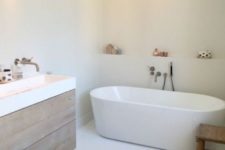 25 a modern white bathroom with a wooden vanity and a wooden stool