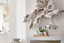 26 a large whitewashed piece of driftwood is a unique wall art idea for a coastal home