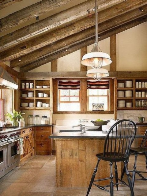 a rustic countryside kitchen with wooden beams and open storage plus pendant lamps and windows for much light