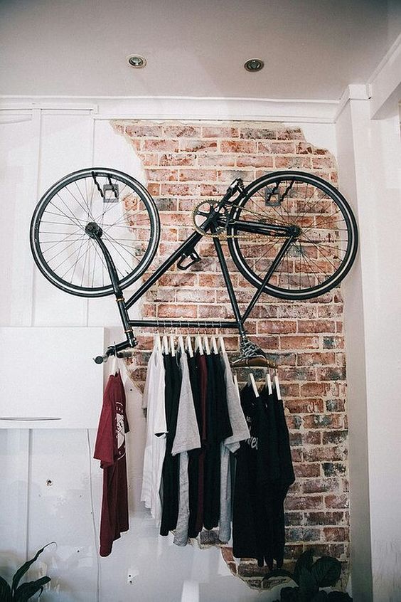 a super cool t-shirt rack made of a bicycle for an edgy touch to your interior