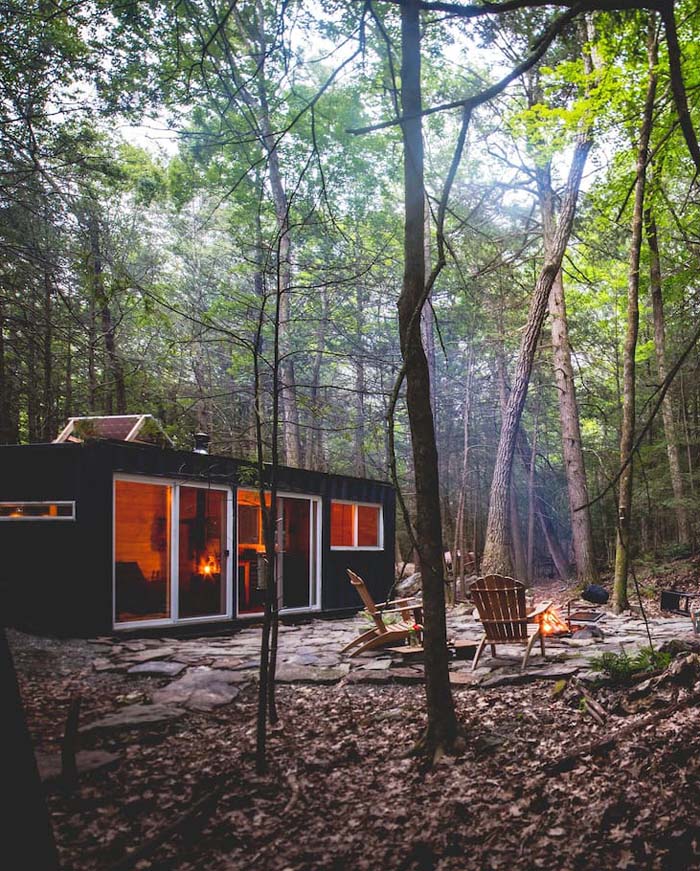This small forest cabin is made of a shipping container and features everything necessary for a nice rest