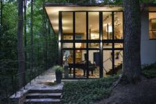02 The house features much glazing, which allows enjoying the forest views and enough light that comes through the branches