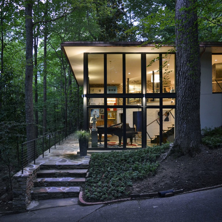 The house features much glazing, which allows enjoying the forest views and enough light that comes through the branches