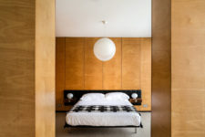 02 The master bedroom is clad with light-colored plywood, there’s a comfy bed and a couple of wardrobes