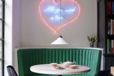 02 a bright dining space with a green banquette seating and a gorgeous neon sign