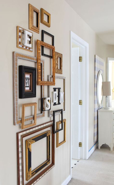 a gallery wall of mixed empty frames and monograms looks very exquisite and adds style