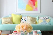 02 a mint sofa is a soft base for adding bright colors with the rug and the artwork for a cheerful feel