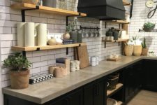 02 a rustic industrial kitchen with black cabinets and concrete countertops plus touches of light-colored wood