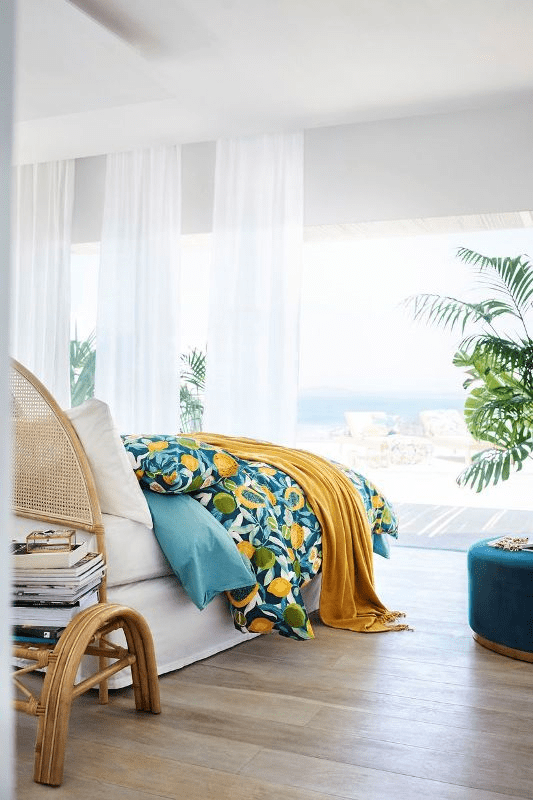 Dress up your bedroom with colorful tropical textiles to bring summer vibes