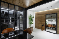 03 The entryway is done with a large mirror that visually expands the space and a wall clad with wood