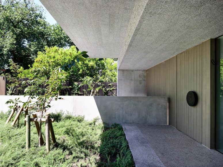 The outdoor spaces are designed in a fresh and a bit wild way to enliven the minimalist facade