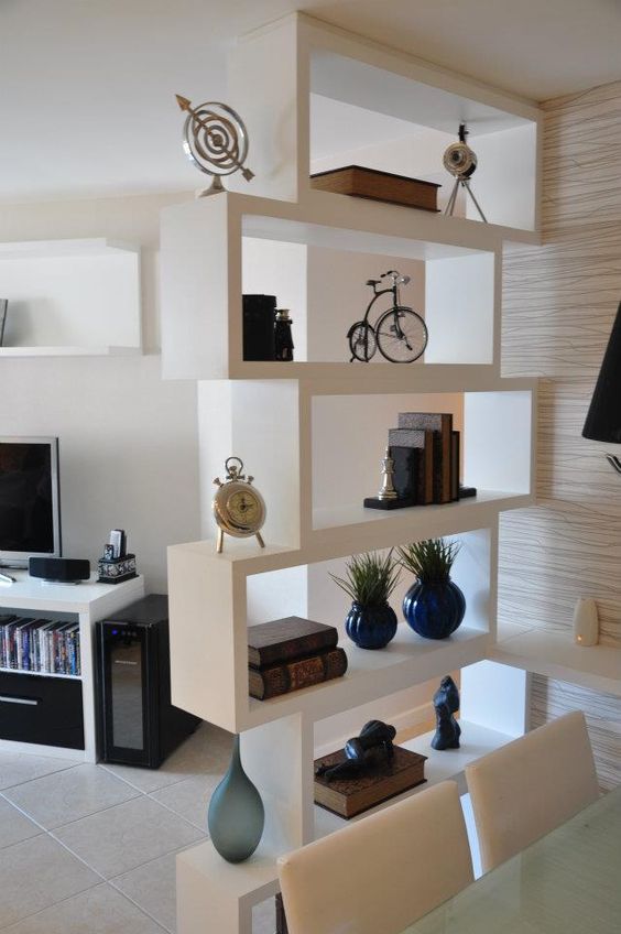 a contemporary white shelving unit makes the dining space visually separated