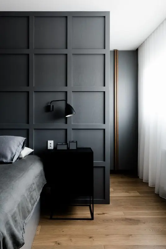 a graphite grey molded statement wall accentuates the bed instead of a headboard