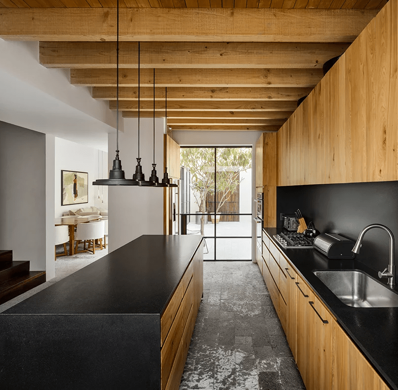 The kitchen was done with dark metal and light colored wood for a strong contrast
