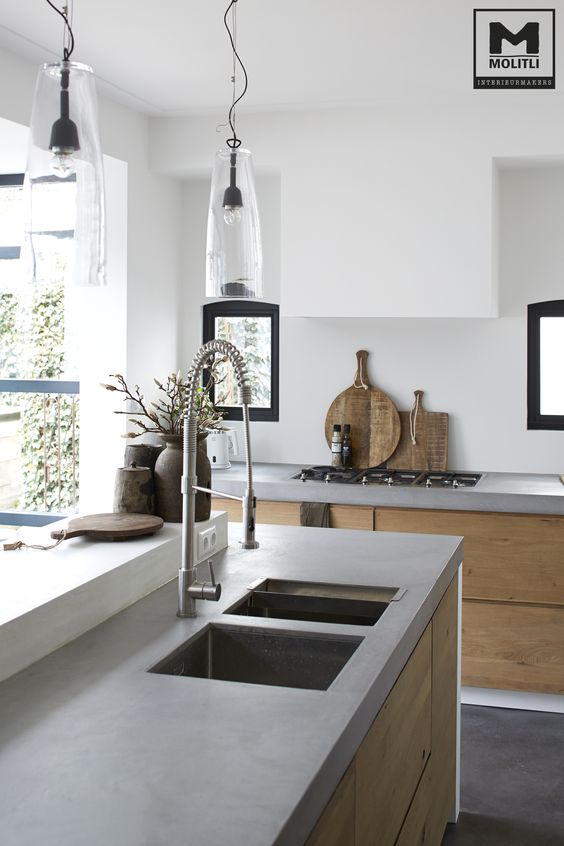 a serene contemporary space with light-colored wooden cabinets, upper white ones and concrete countertops