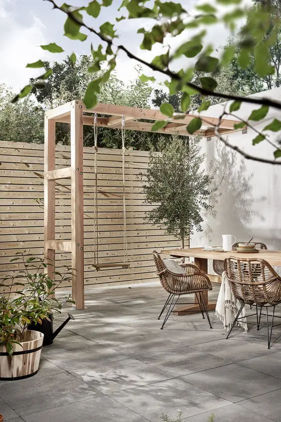 make a light-colored wood plank fence with little space in between the planks for more privacy