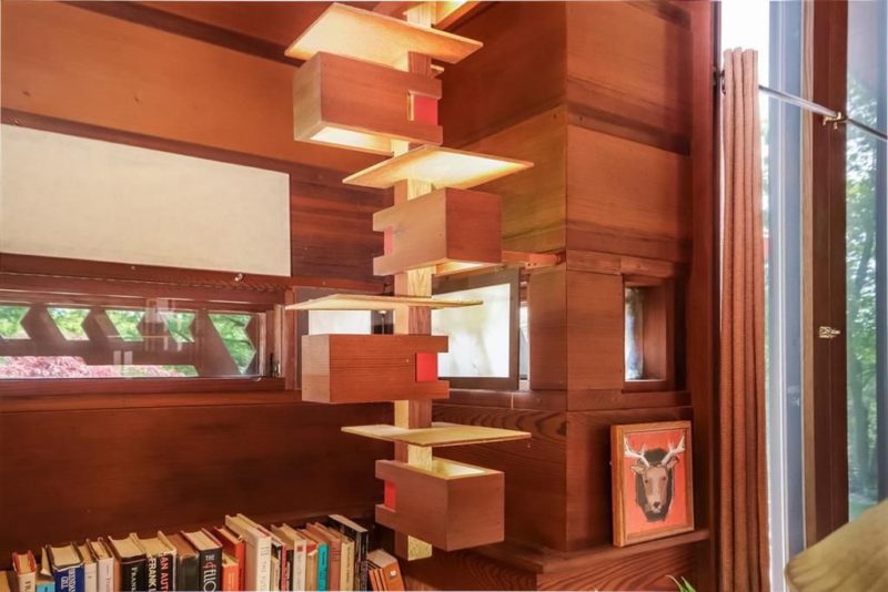The design of the house contains signature Wright's elements in eahc point including these lit up shelves