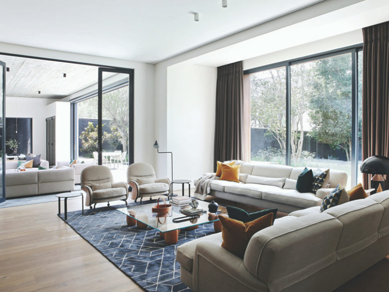 The living room is done with a panoramic window, and glass doors separate the living and dining spaces