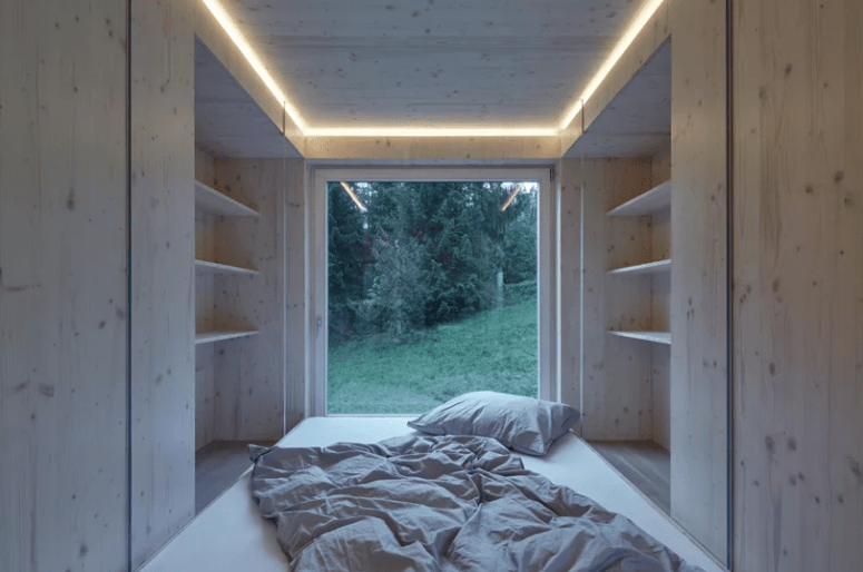 There's a sleeping space combined with an open closet, and of course an opening to enjoy the views
