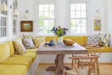 05 a colorful dining room with a bright yellow corner velvet banquette seating