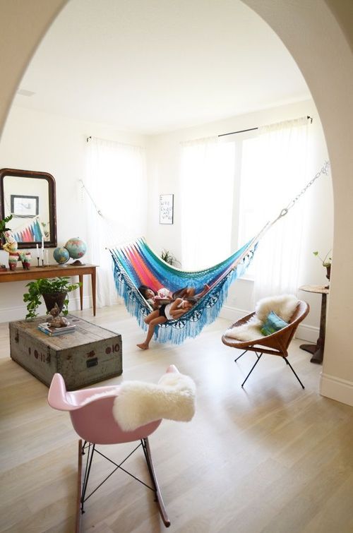 a colorful hammock hung in an alcove is a fun and bright touch to any neutral space